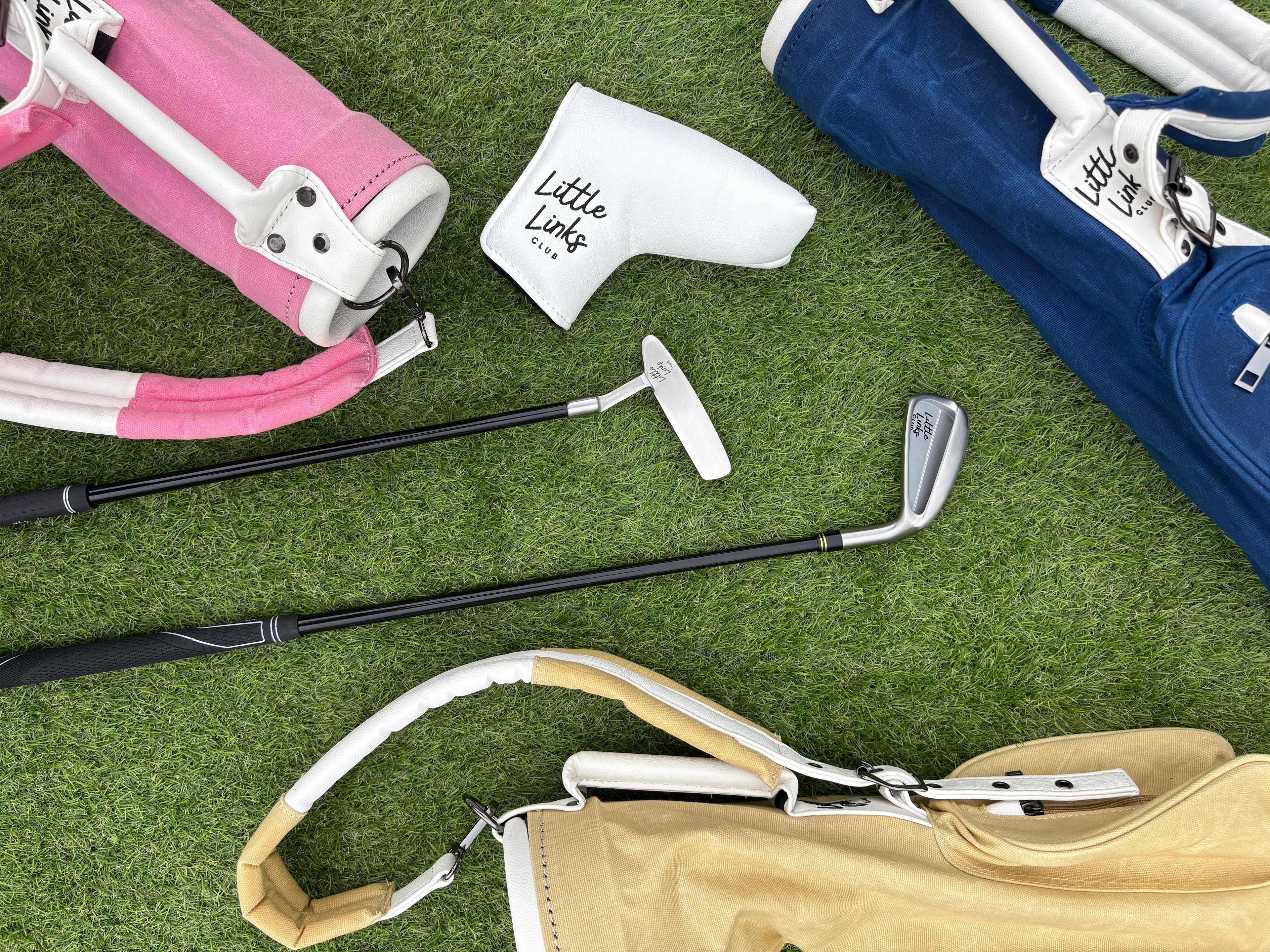 Golf clubs and bags on a grassy surface
